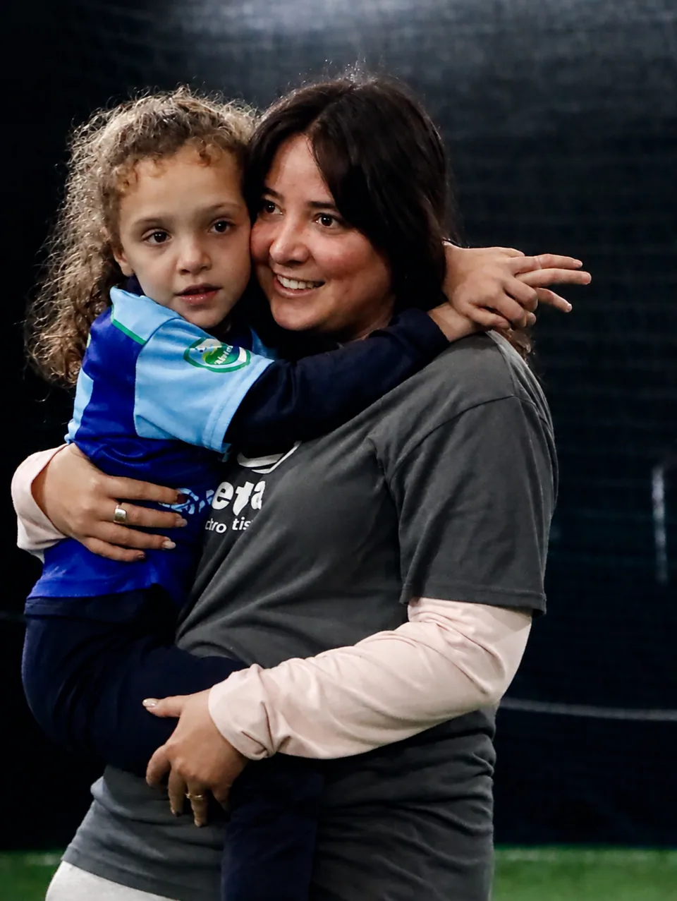 Una niña abraza a una acompañante durante una jornada de Fútbol sin Barreras