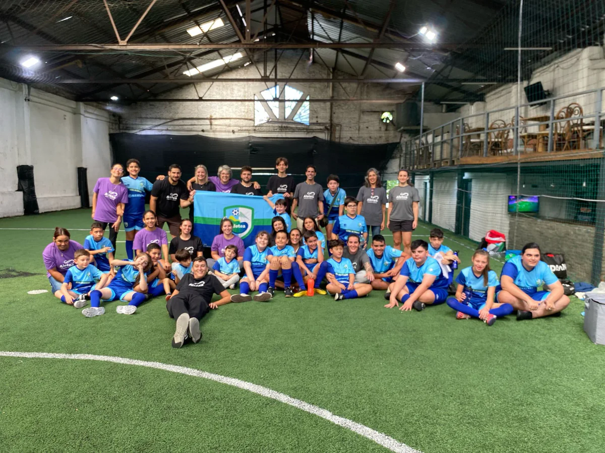 Participantes y equipo de Aletea reunidos en una cancha de fútbol